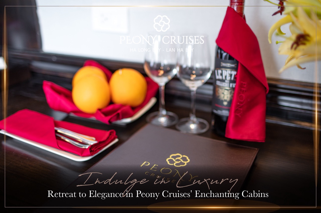 Elegant cruise dining scene with wine, fruits, and fine table setting in Halong Bay.