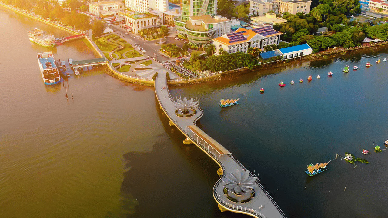 Colorful cityscape with scenic riverfront and modern architecture in Vietnam.