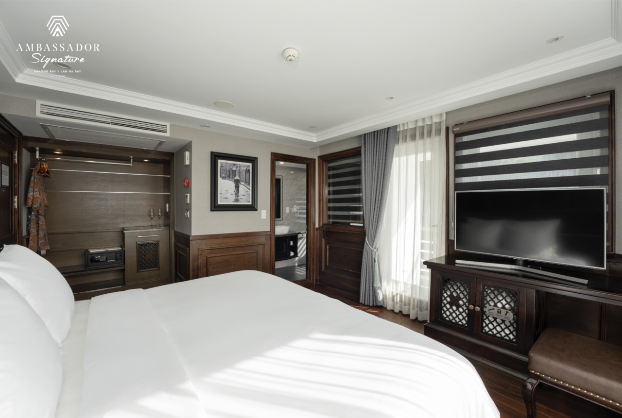 Elegant cruise cabin with modern decor and ocean views, perfect for a relaxing Halong Bay experience.