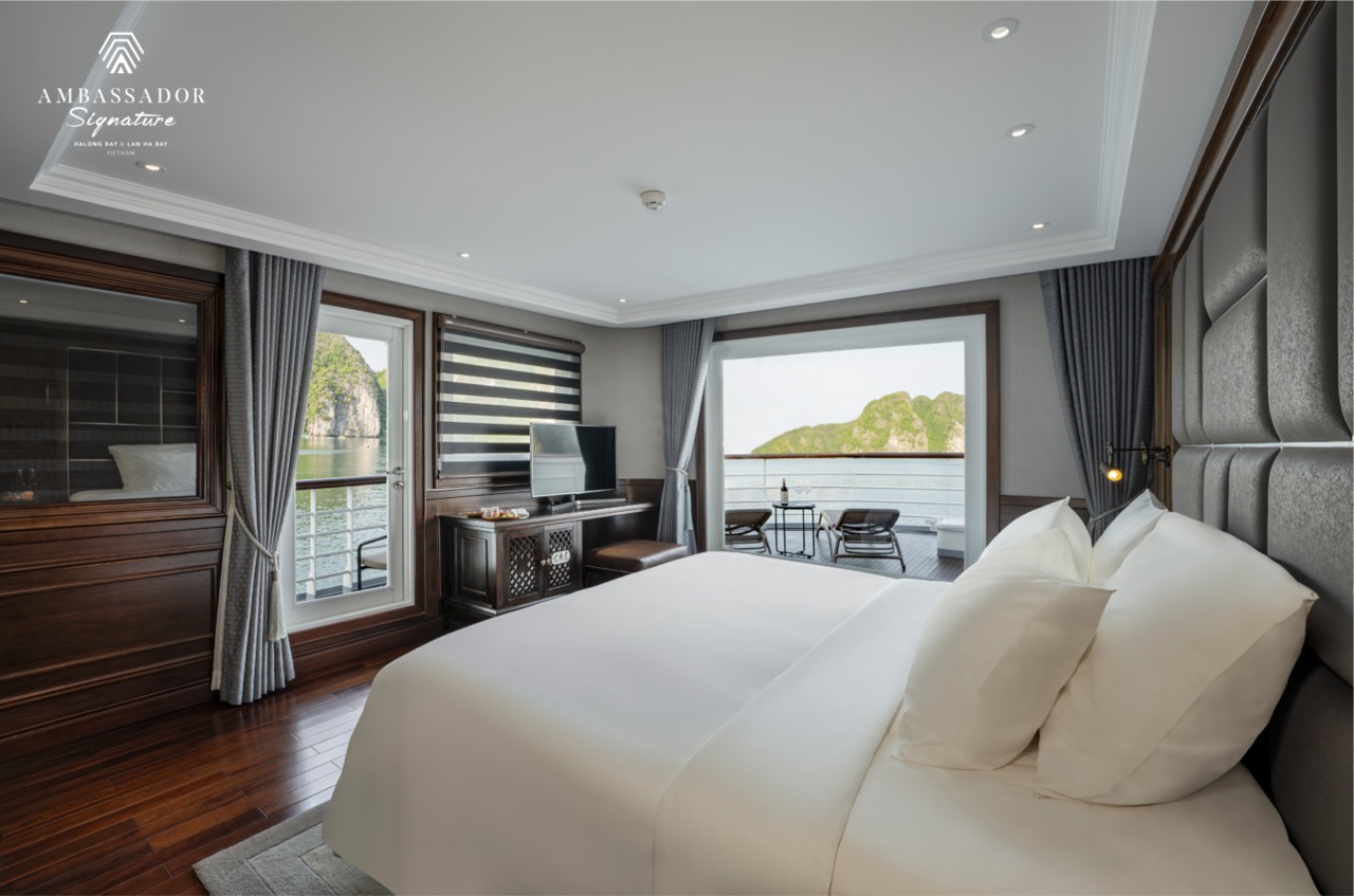 Stunning cruise balcony view of Halong Bay with lush islands, perfect for a romantic getaway or scen.