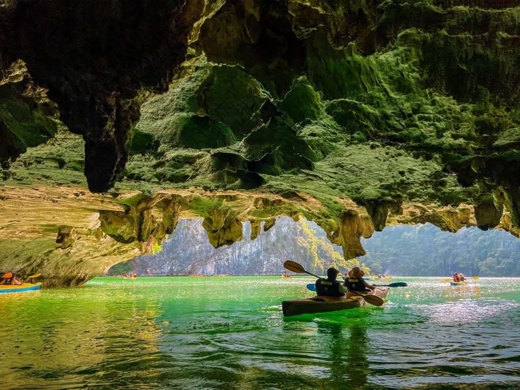 Kayaking in Lan Ha Bay with stunning limestone karsts and emerald waters.