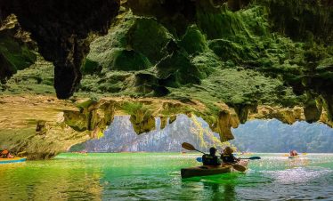 Kayaking in Lan Ha Bay with stunning limestone karsts and emerald waters.