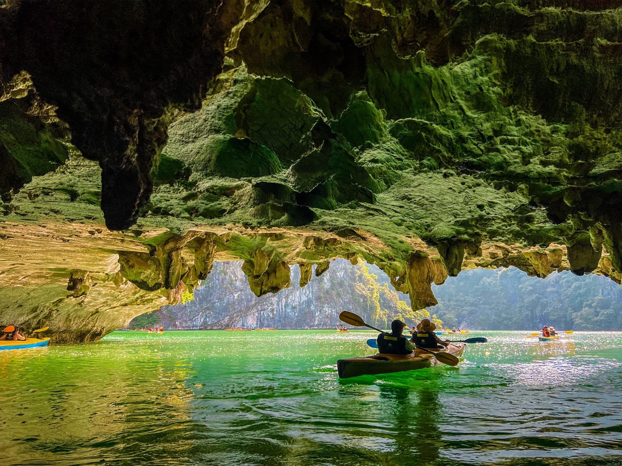 Kayaking in Lan Ha Bay with stunning limestone karsts and emerald waters.