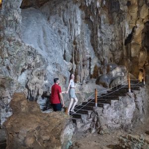 cave-tour-couple-stone-staircase-amanda-halong-cruise-halong-bay-viettrendtour