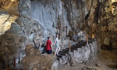 Stalactite cave tour in Vietnam with guided exploration and stunning mineral formations.