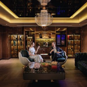 Elegant lounge with luxurious wood-paneled walls and modern lighting, perfect for upscale relaxation.