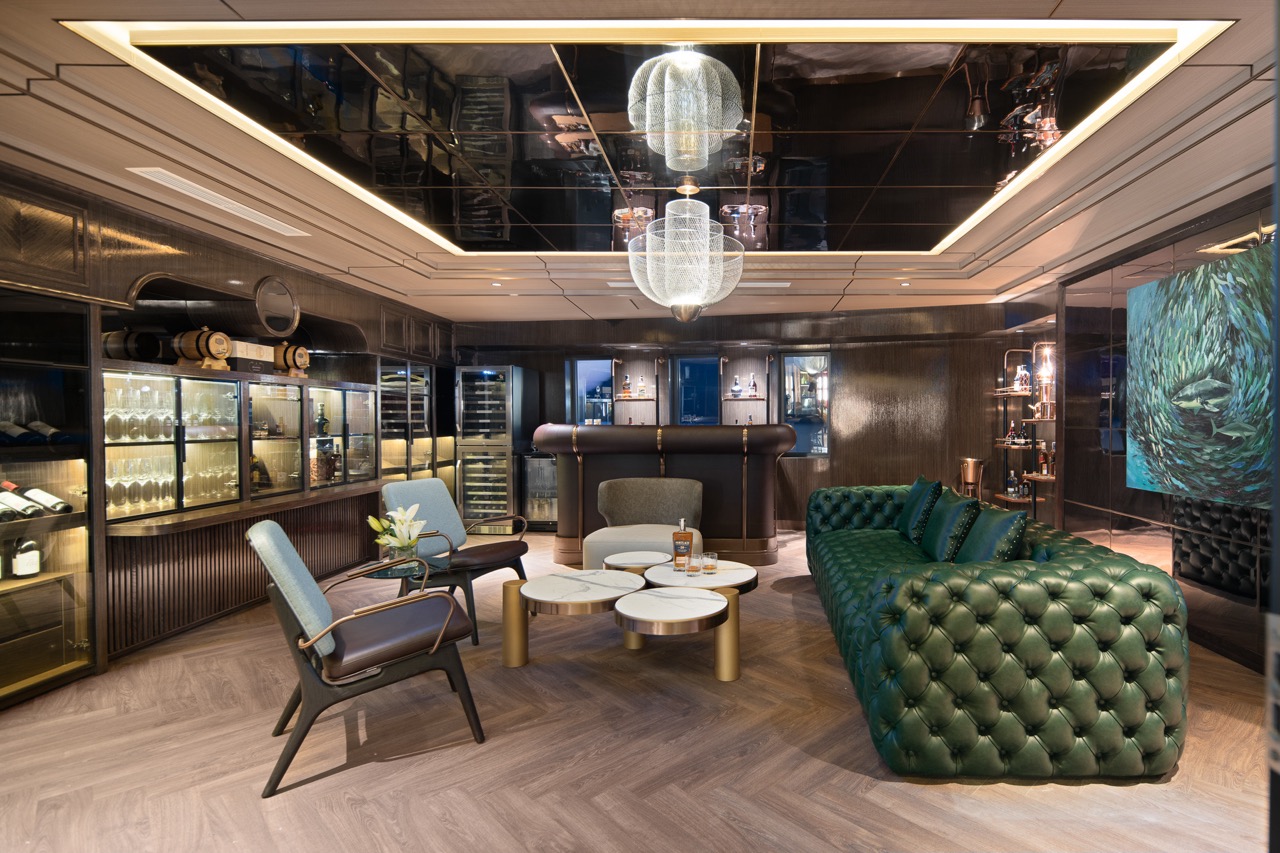 Luxurious Modern Lounge with Green Leather Chesterfield Sofa and Elegant Lighting.