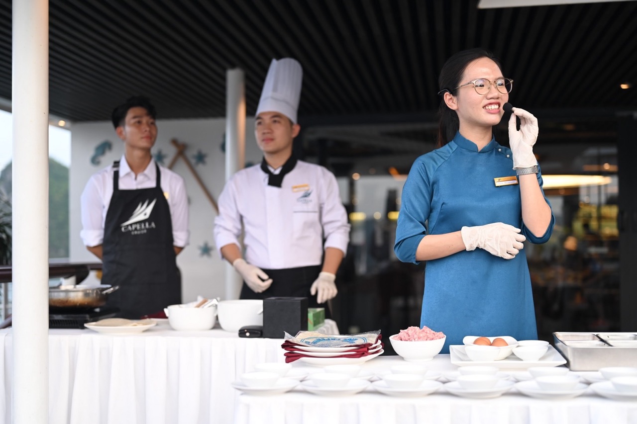 Culinary chef team preparing dishes at ViettrendTour cooking class, Vietnamese food experience.