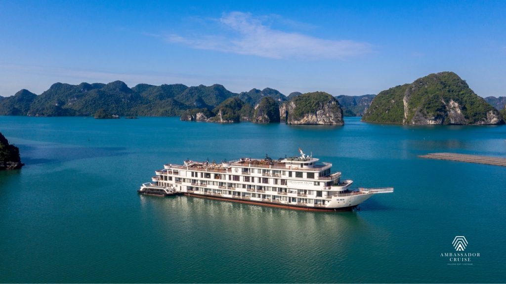 Ambassador Cruise Halong Bay ship sailing through turquoise waters of Halong Bay, scenic limestone islands, peacef.