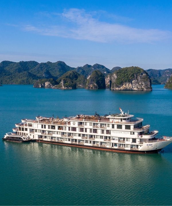 Ambassador Cruise Halong Bay ship sailing through turquoise waters of Halong Bay, scenic limestone islands, peacef.