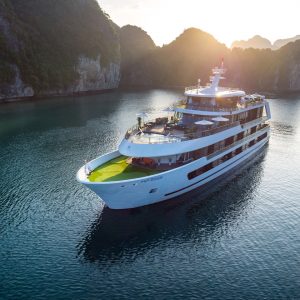 Full view of Stellar Of The Seas sailing between limestone cliffs in Lan Ha Bay, Vietnam. Join ViettrendTour for a stylish Halong Bay overnight cruise.