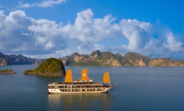Beautiful Halong Bay landscape with boat sailing on calm waters.