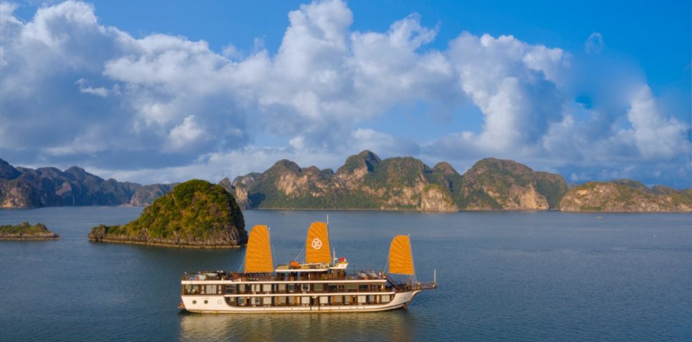 Beautiful Halong Bay landscape with boat sailing on calm waters.