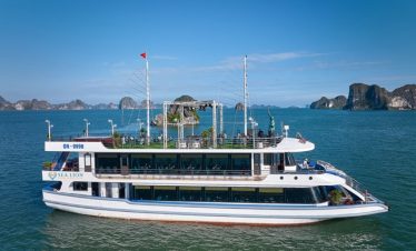 Cruise ship on Halong Bay with scenic limestone islands and clear blue waters.