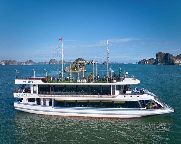 Cruise ship on Halong Bay with scenic limestone islands and clear blue waters.