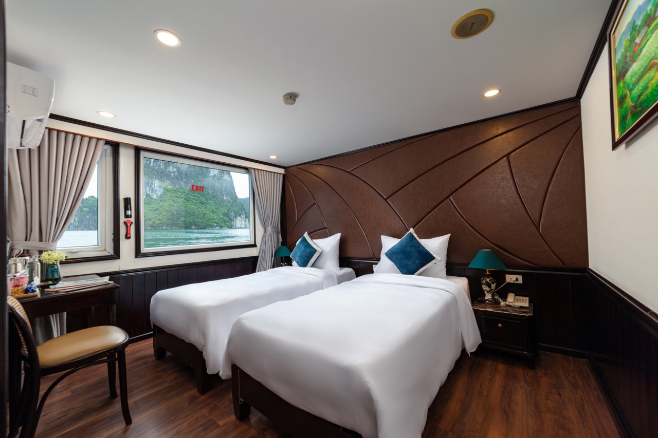 Elegant hotel room with river view and modern furnishings.
