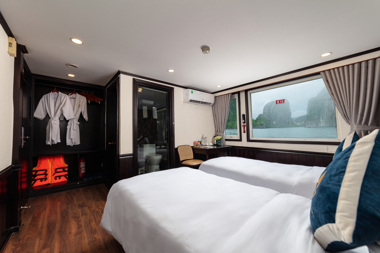 Ocean view hotel room with contemporary decor and balcony overlooking limestone islands, perfect for travel and leisure.