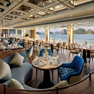 Luxurious cruise ship restaurant with panoramic ocean views and elegant decor.