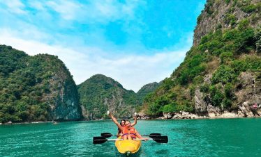 Kayaking in Halong Bay with stunning limestone karsts and clear waters, perfect for an adventurous d.