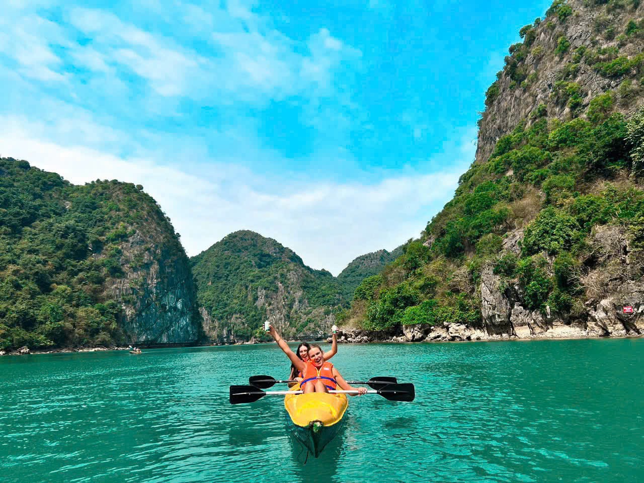 Kayaking in Halong Bay with stunning limestone karsts and clear waters, perfect for an adventurous d.