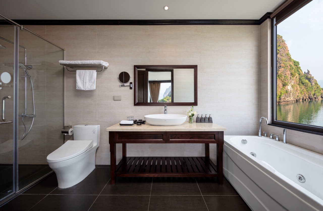 Luxurious bathroom with view of Halong Bay, modern amenities, and scenic water landscape.