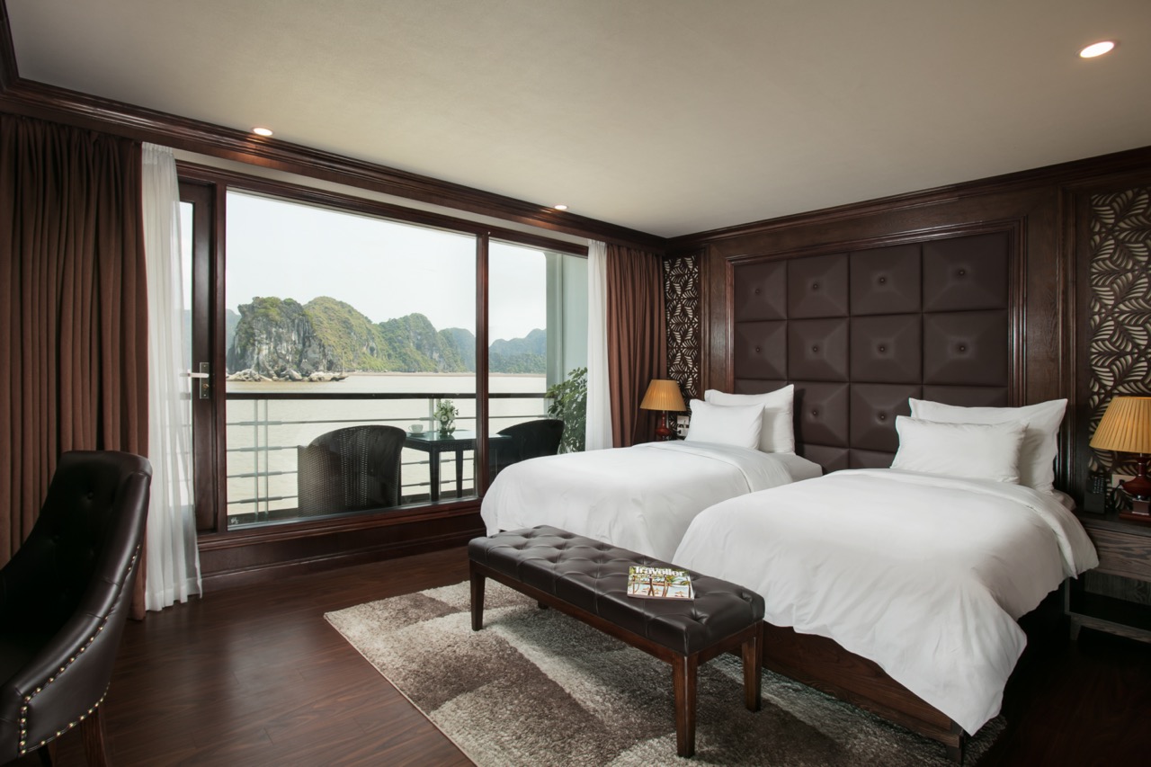 Stunning view from a luxury cruise balcony in Halong Bay, showcasing serene waters and lush islands.