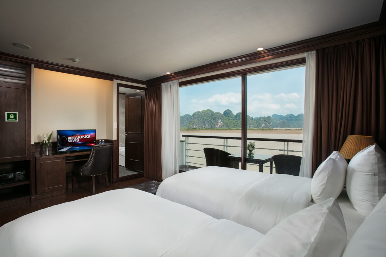 Stunning view from the cruise balcony overlooking Halong Bay's emerald waters and limestone karsts.