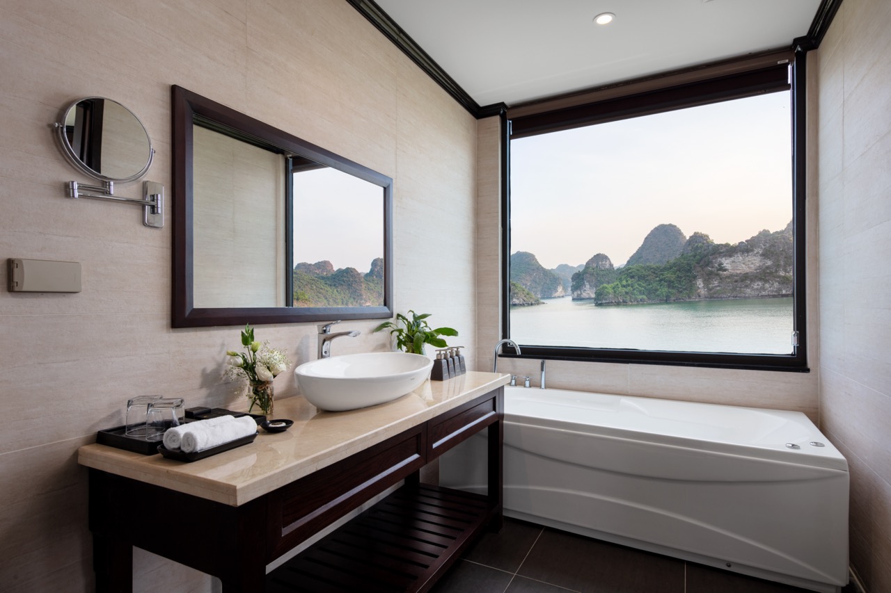 Stunning view of Halong Bay from a modern cruise balcony, perfect for a relaxing and scenic experien.