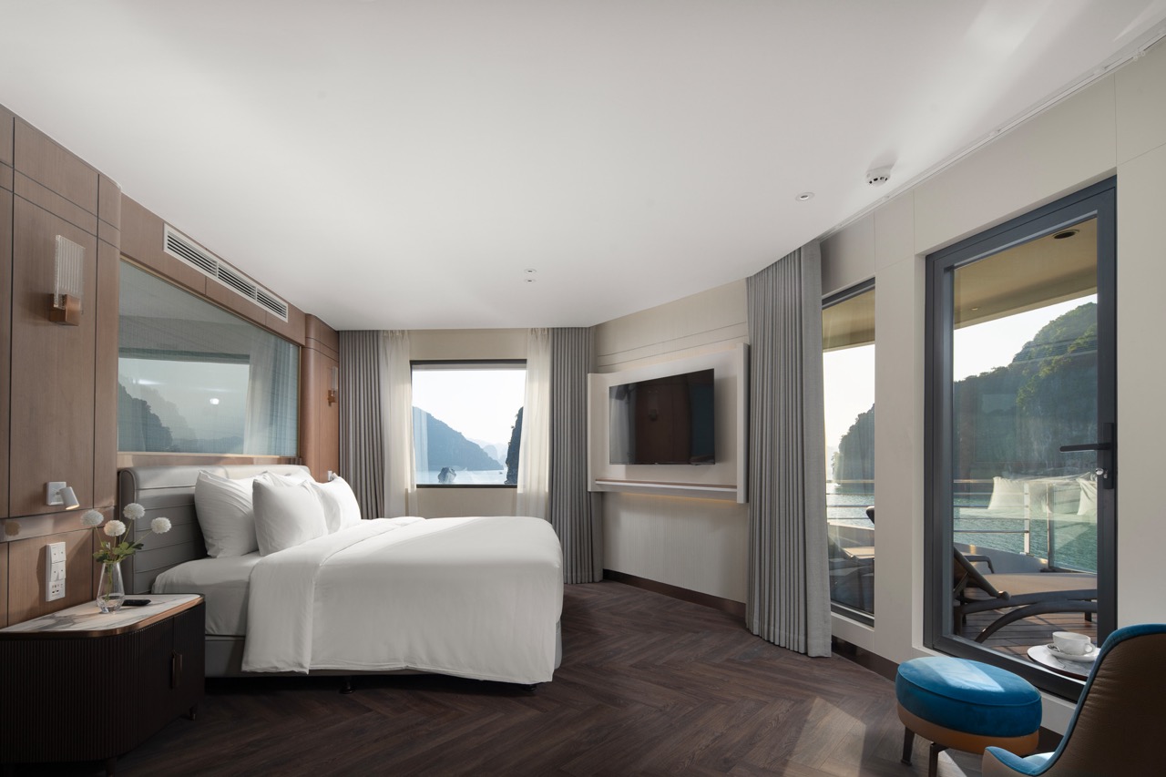 Luxurious hotel room overlooking scenic water views with modern amenities and balcony access.
