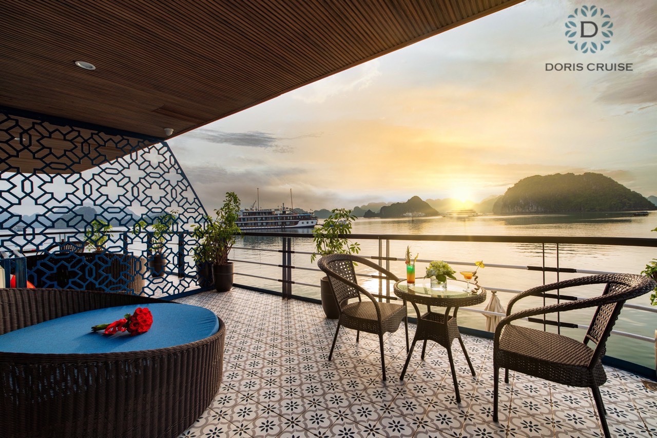 Stunning Halong Bay sunset view from luxury cruise balcony with relaxing ambiance.