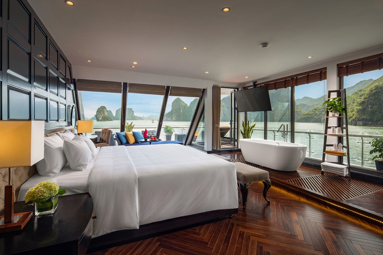 Luxurious riverside hotel suite with bathtub and stunning mountain views in Vietnam.