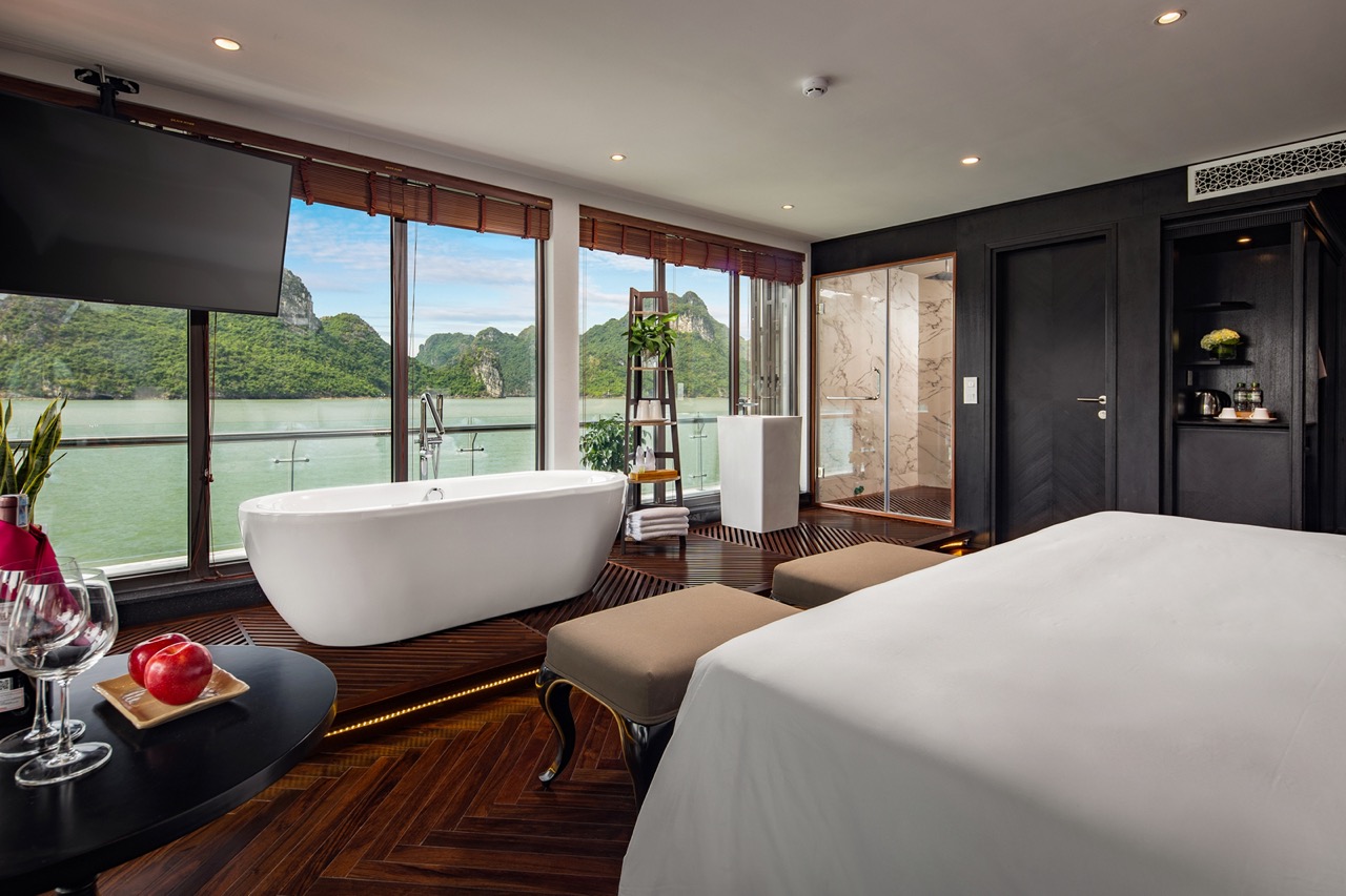 Luxurious river view hotel room with bathtub, modern decor, and scenic landscape in Vietnam.