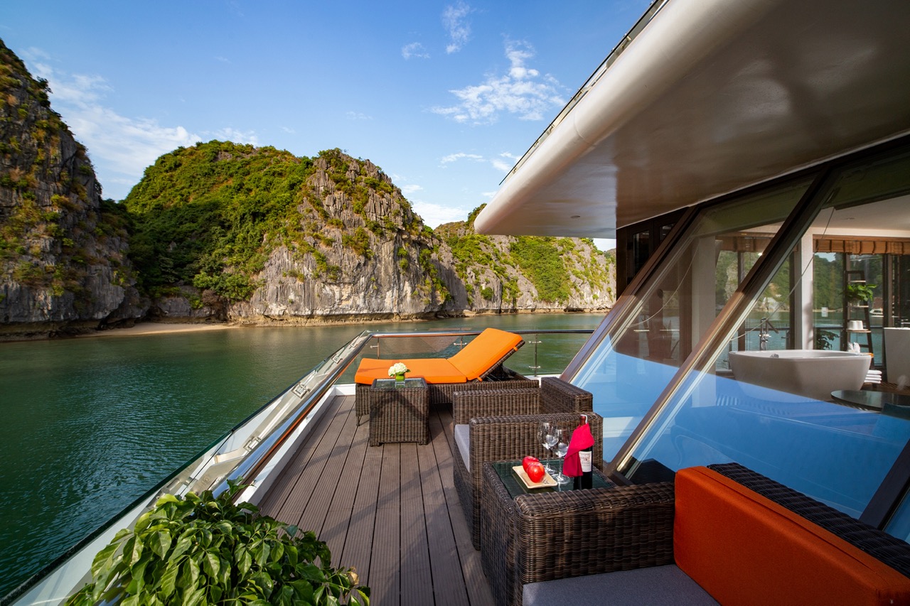 Luxurious yacht cruising through stunning limestone karsts in Ha Long Bay, Vietnam.