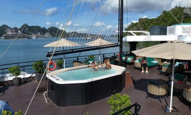 Hot tub with guests enjoying the view on Lan Ha Bay cruise, surrounded by scenic limestone islands a.