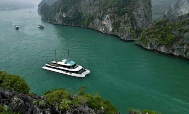 Lan Ha Bay cruise balcony with stunning limestone karsts and emerald waters.