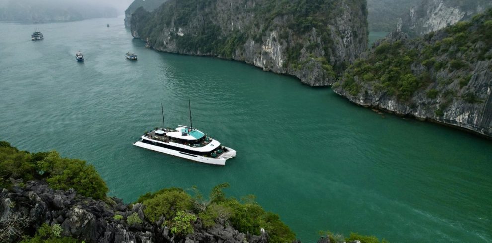 Lan Ha Bay cruise balcony with stunning limestone karsts and emerald waters.
