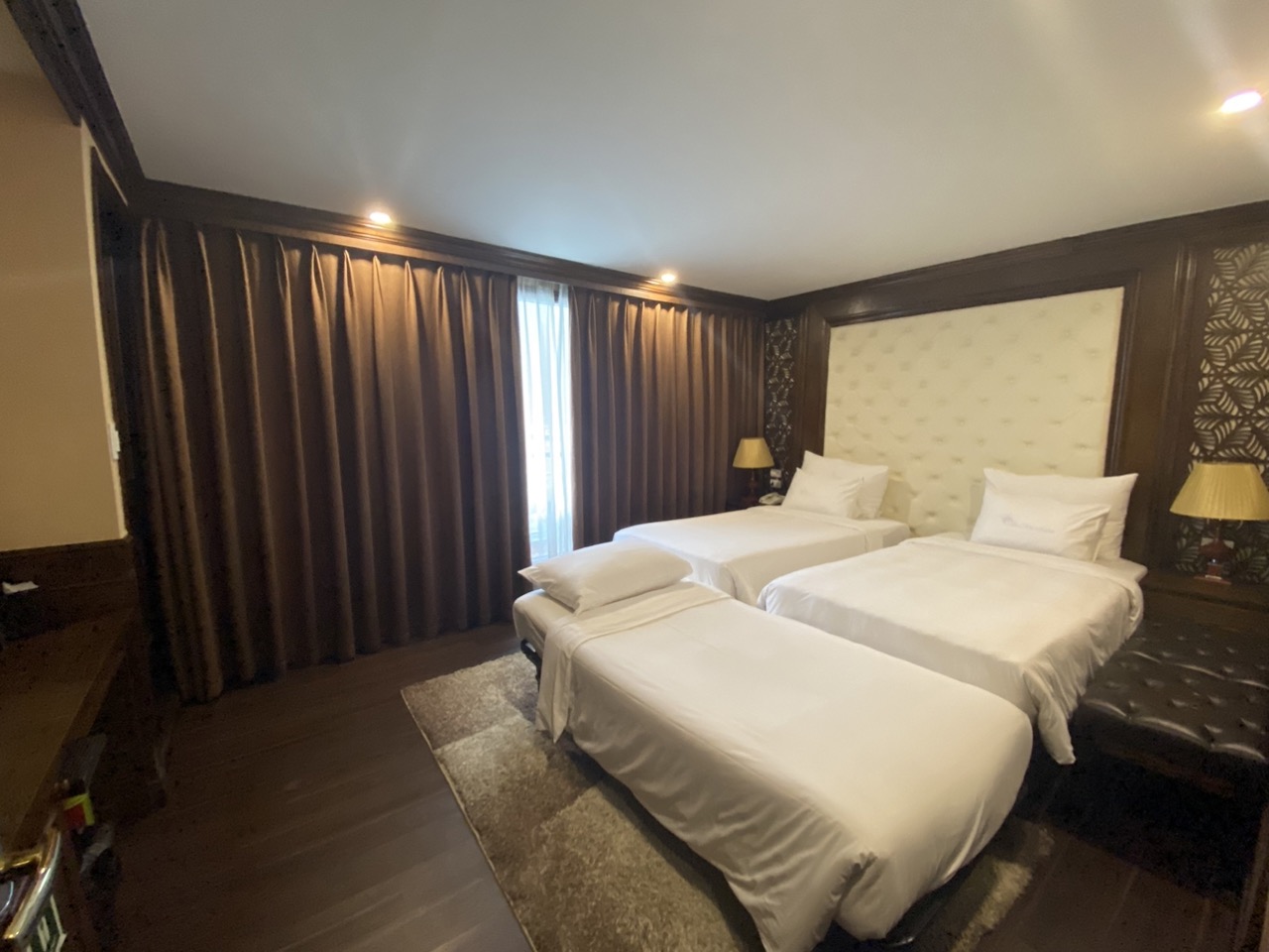 Luxurious cruise balcony room in Halong Bay with elegant decor and cozy ambiance.