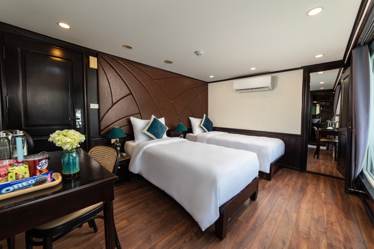 Comfortable hotel room with twin beds, modern decor, and amenities for a perfect stay in Vietnam.