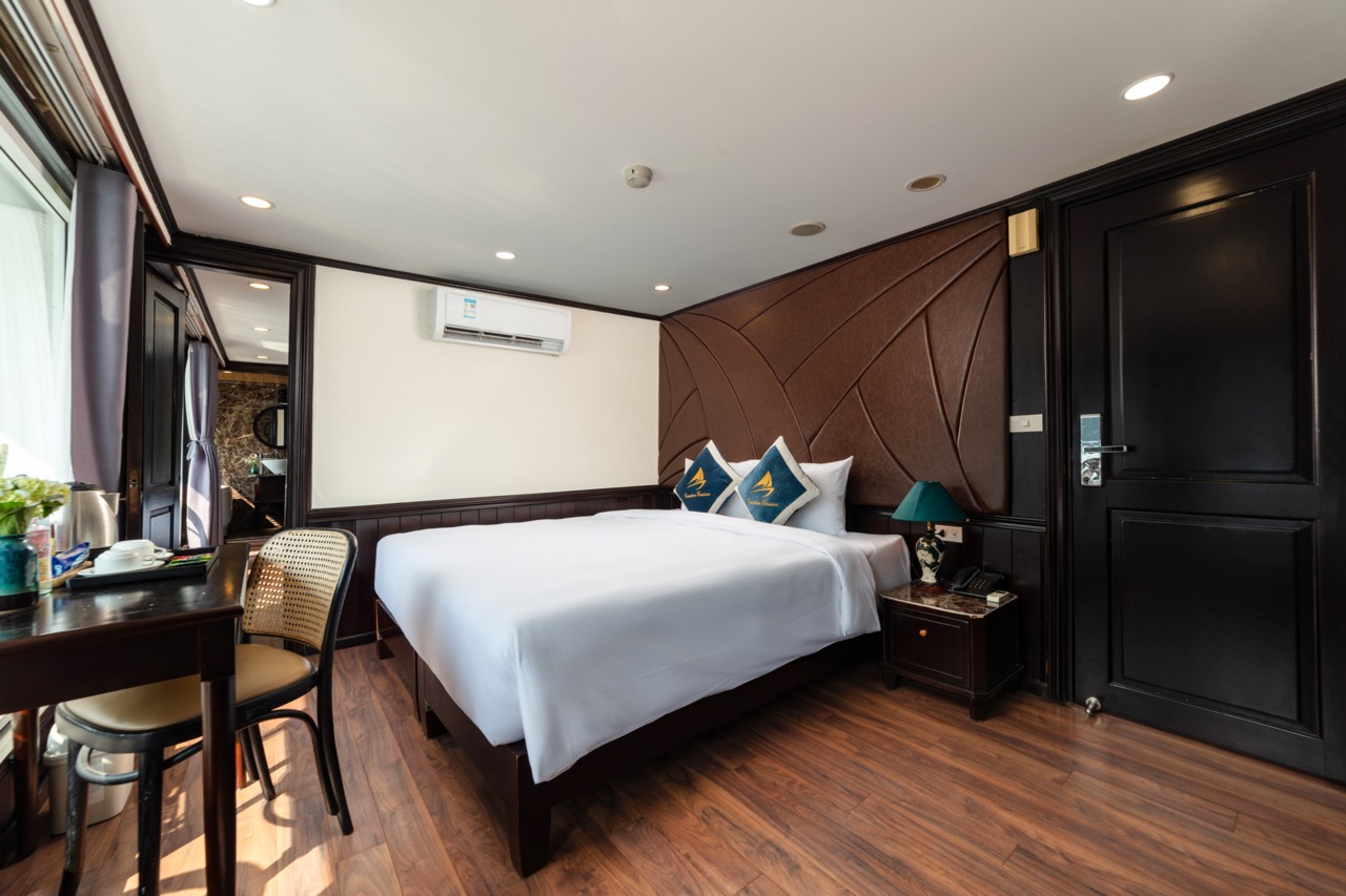 Comfortable hotel room with king-size bed, modern decor, and amenities in Vietnam.