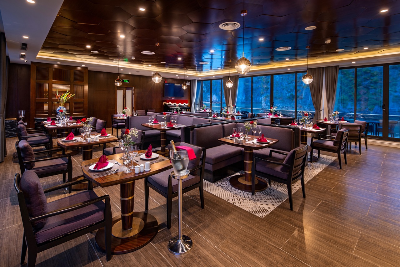 Luxurious restaurant interior with elegant table settings and modern decor.