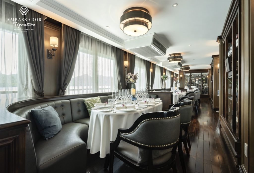 Luxurious cruise dining room with elegant decor and panoramic views of Halong Bay, perfect for a 2-d.