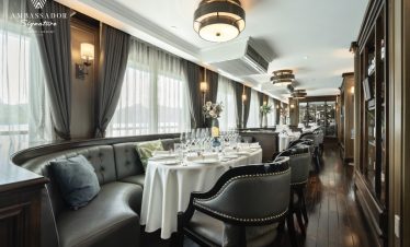 Luxurious cruise dining room with elegant decor and panoramic views of Halong Bay, perfect for a 2-d.