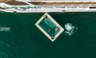 Aerial view of a luxury cruise balcony with a swimming pool in Halong Bay, showcasing serene waters.