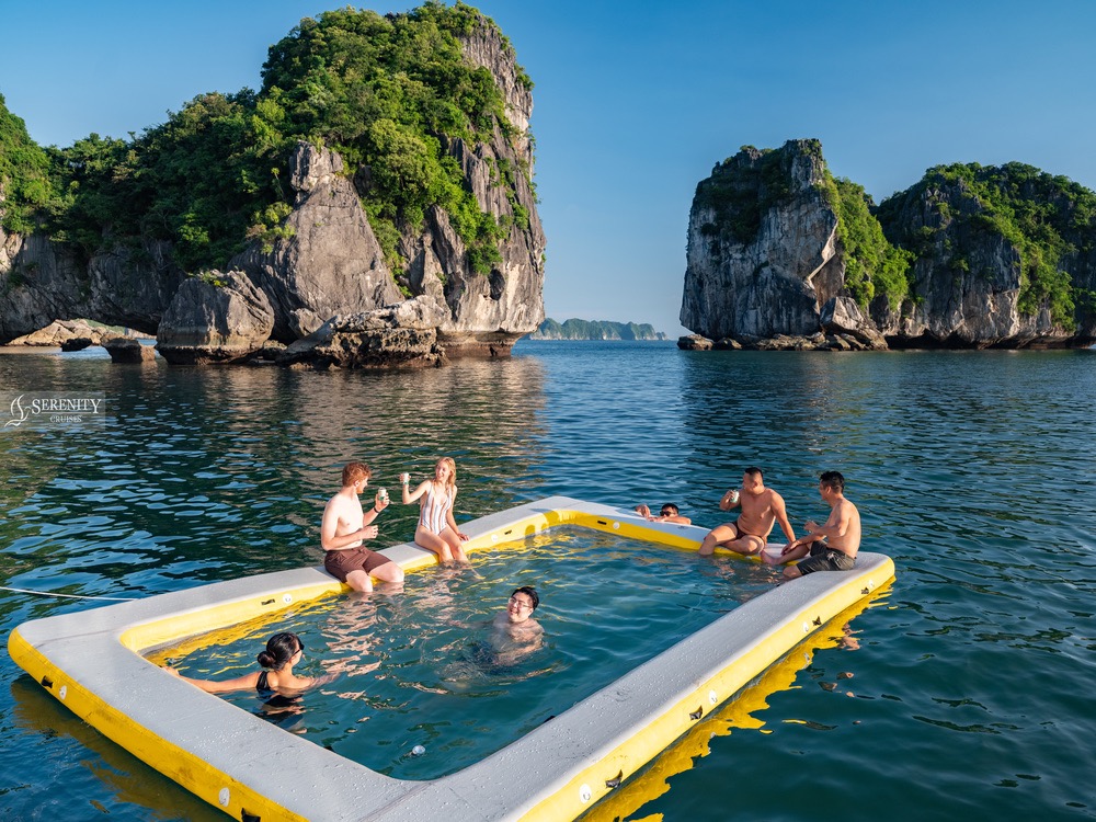 Swimming and relaxing in a scenic Lan Ha Bay setting with limestone karsts in the background.