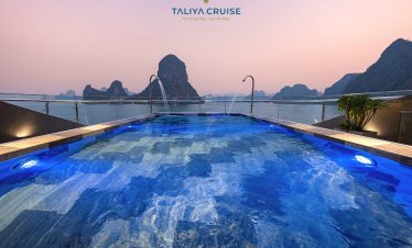 Stunning view from the cruise balcony overlooking limestone karsts in Lan Ha Bay at sunset.