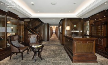 Elegant wooden decor and cozy seating area on a premium cruise experience.