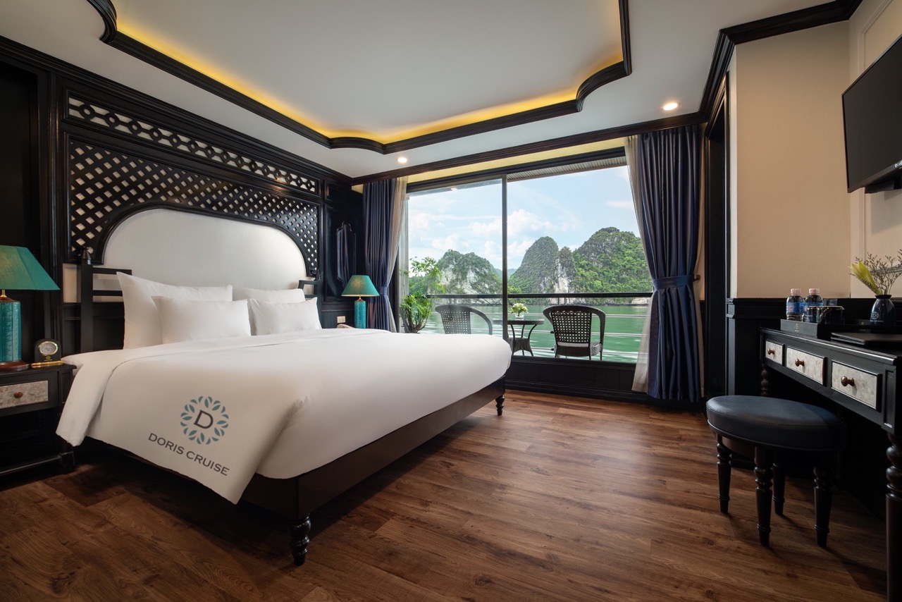 Stunning cruise balcony view of Halong Bay with lush islands, perfect for a luxurious travel experie.