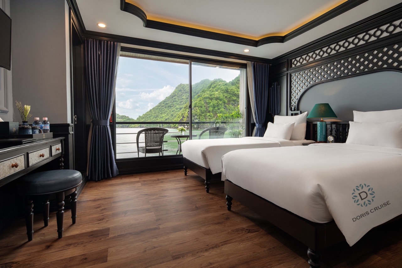 Scenic view of Halong Bay from cruise balcony with modern interior, perfect for a relaxing getaway.