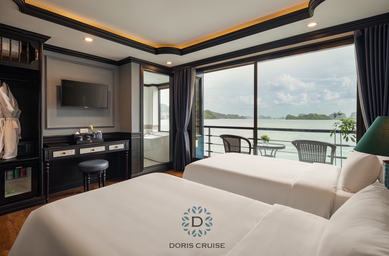 Stunning view from a luxury cruise balcony overlooking Halong Bay's emerald waters and limestone kar.