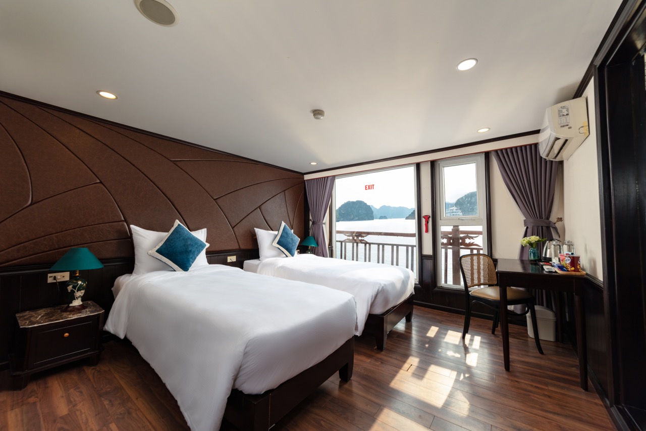 Modern hotel room with sea view, twin beds, balcony, and luxurious furnishings for a perfect Vietnam travel experience.